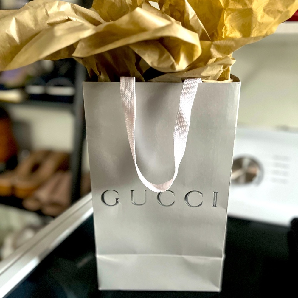 Gucci bag and paper